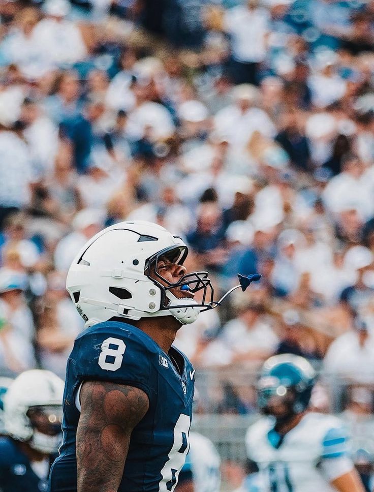 Penn State player in white helmet on the sideline